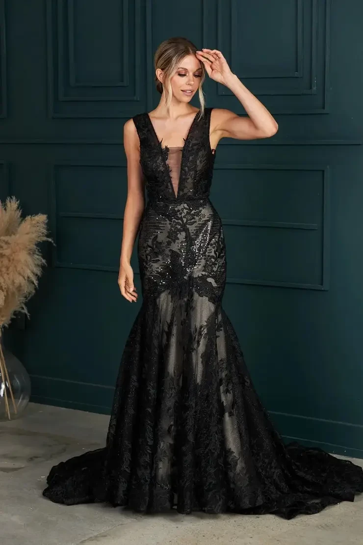 model is wearing a black lace wedding gown