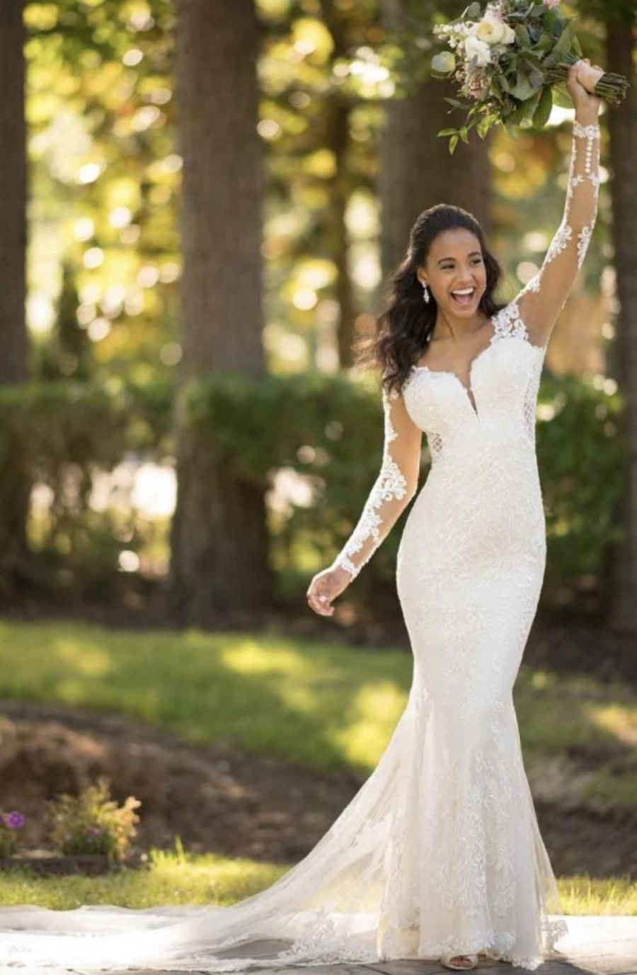 model is wearing a fit and flare wedding dress