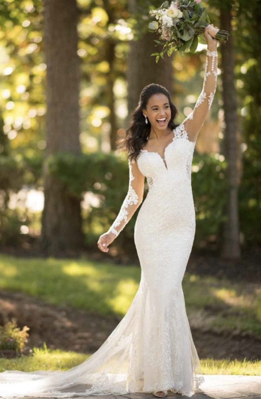 model is wearing an illusion long sleeve fit and flare bridal gown